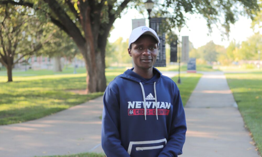Longei proudly wears his cross-country sweatshirt on Newman's campus.