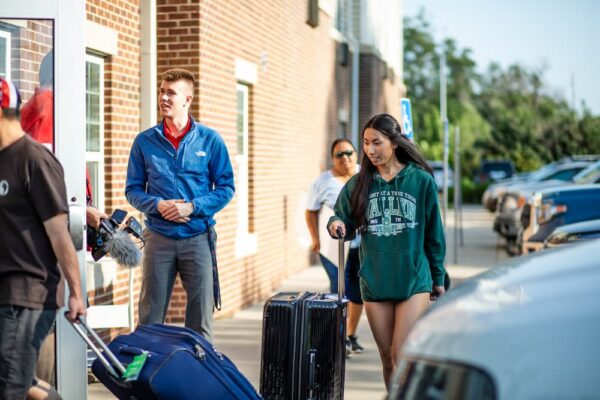 Malie Noda rolls her suitcase into Carrocci Hall on move in day.