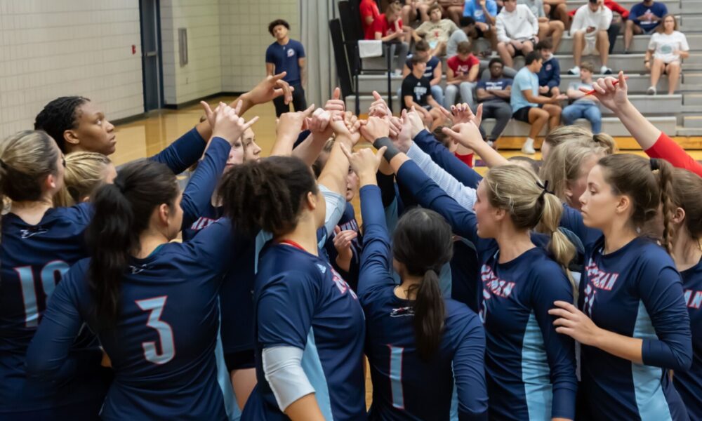 The women's volleyball team comes together before a big game.