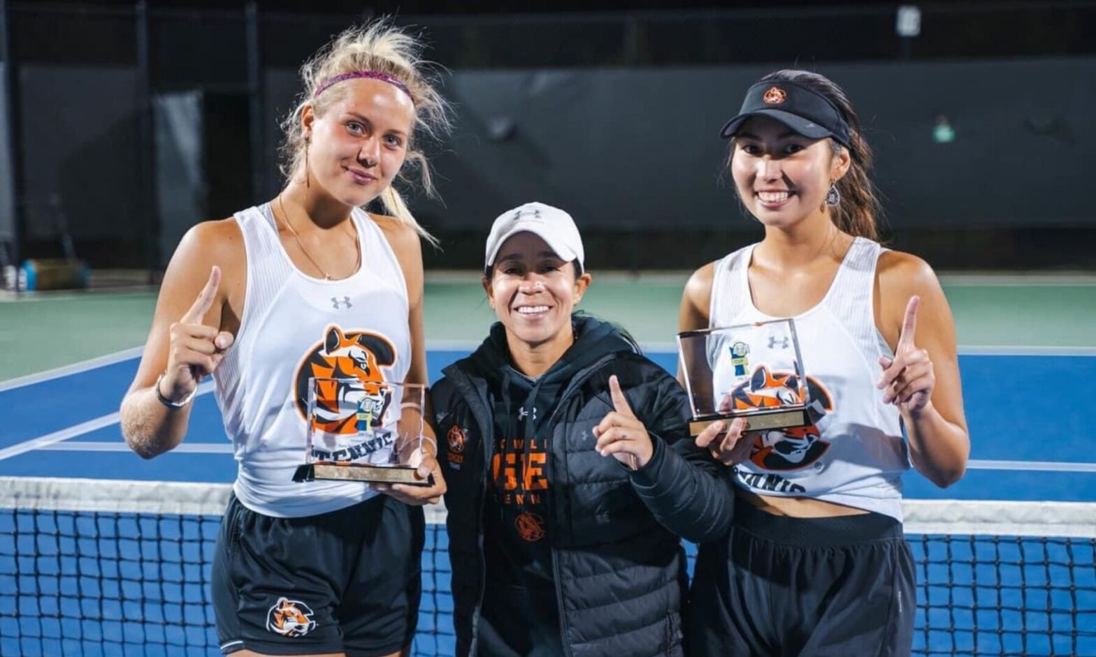 Raga (center) with two of her Cowley Tigers women's tennis players. (Courtesy photo)