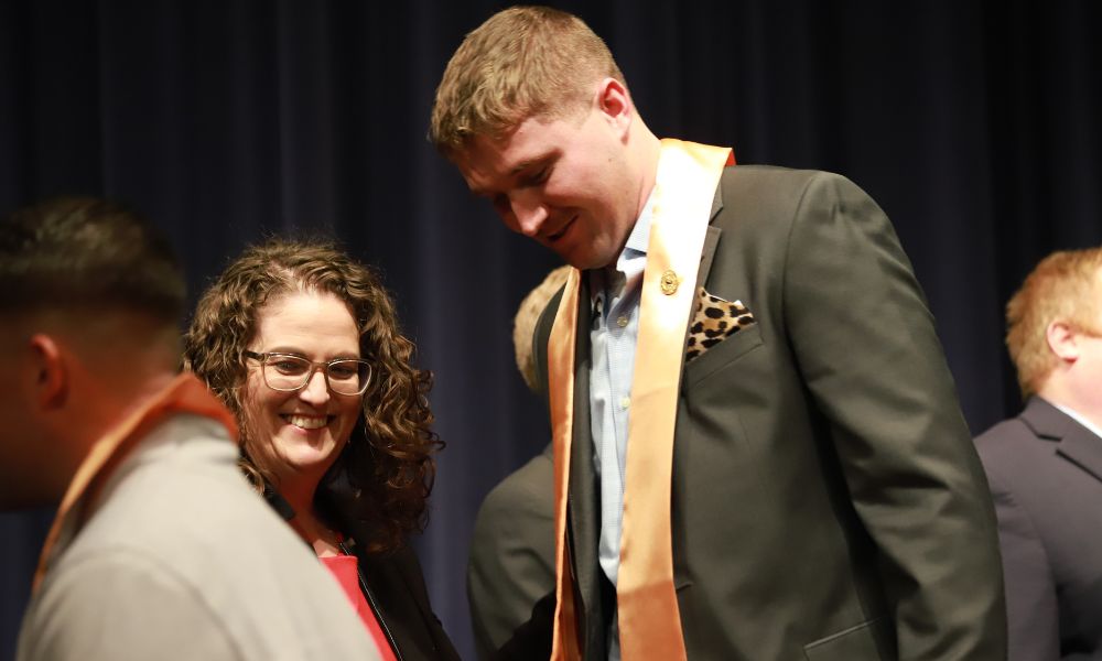Cole Gordon receives his Newman nursing pin during the ceremony.