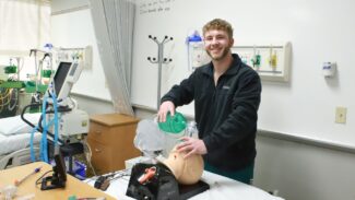 Newman student Bryson Gilchrist demonstrates hands-on respiratory care techniques learned in the classroom.