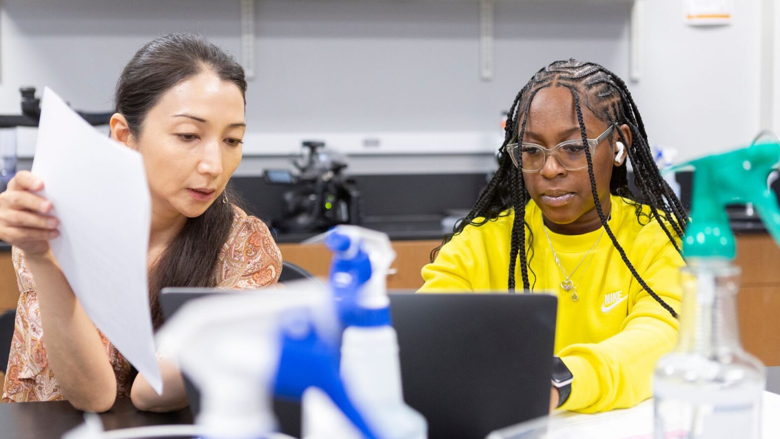 Professor Tomoko Bell, Ph.D. (left) works one-on-one with a student during the Investigative Summer STEM Program at Newman University.