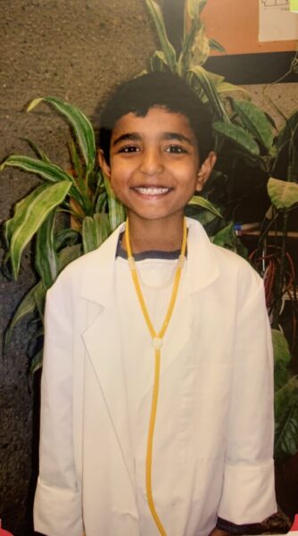 Khokar as a child with his first lab coat and stethoscope.
