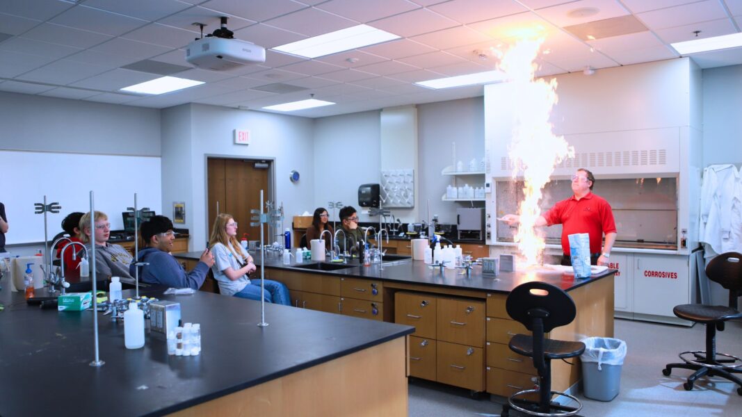 Professor Alan Oberley teaches students chemistry using fire during ISSP.