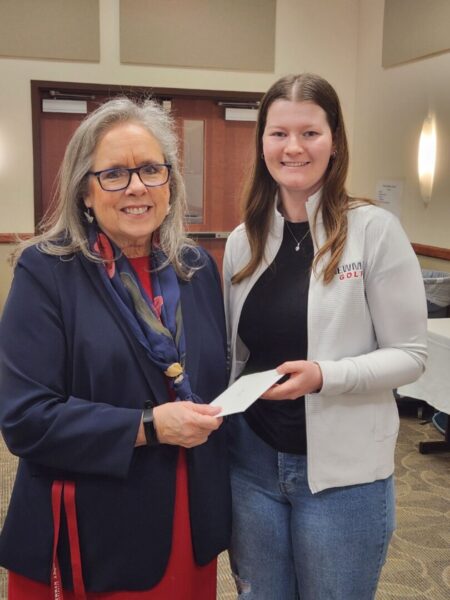 President Jagger hands student Beth Griffiths her cash prize for her essay submission.