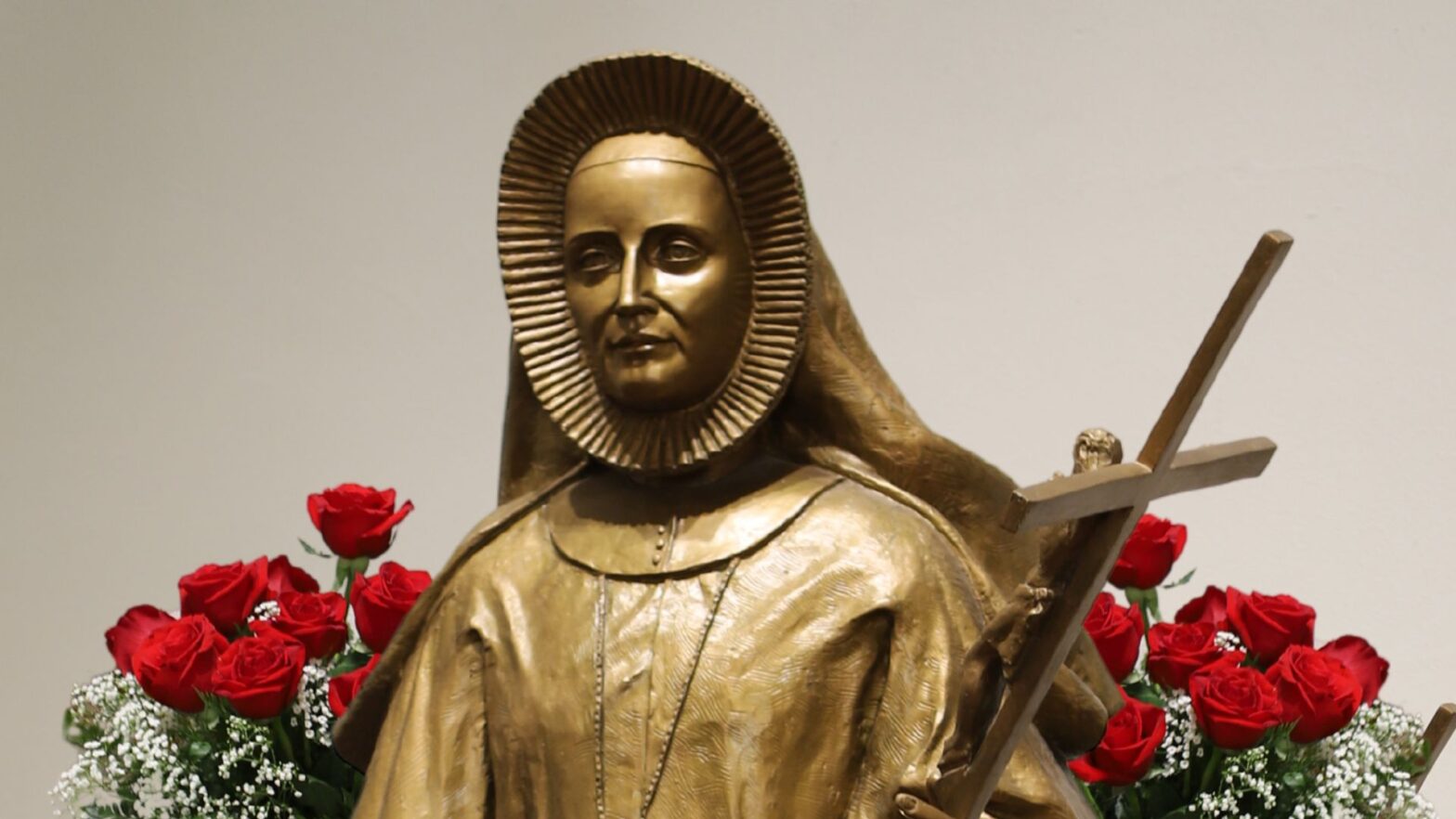 St. Maria De Mattias sculpture with red roses in the background.