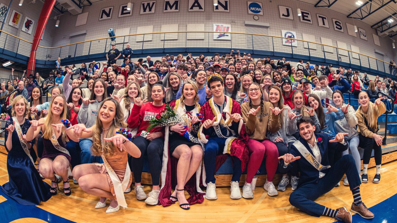 The student body gathers in the stands to celebrate Newman University homecoming night with the newly crowned king and queen.