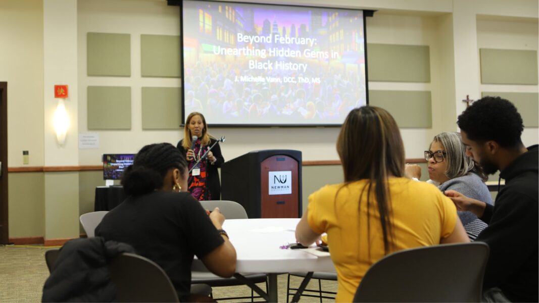Michelle Vann presents during a luncheon at Newman University.