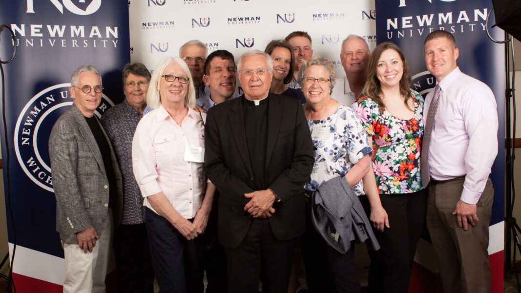 Father Tom Welk (center) surrounded by friends and supporters after winning the St. Newman Medal.