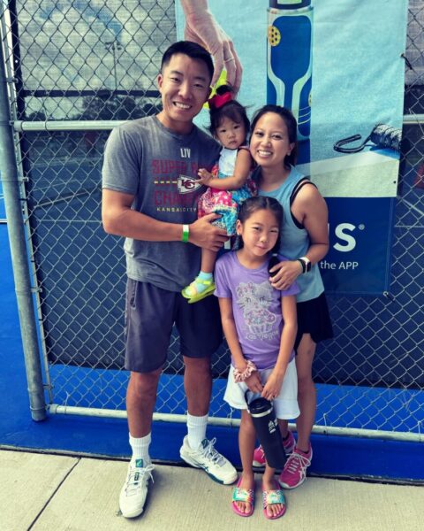 Kim, his wife and two daughters outside a pickleball court.