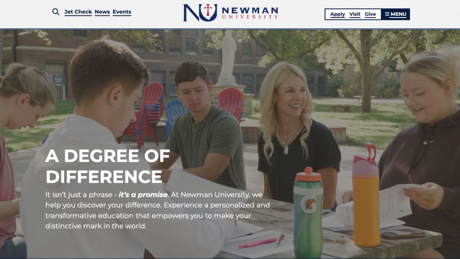 Newman homepage website features video clip of a professor interacting with students at a picnic table during an outdoor class.