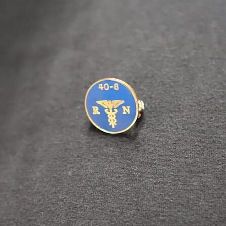 The 40&8 pin with "RN" signifies the support of the veteran group and the nurses' contributions to the community.