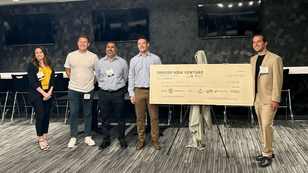 Vasilescu (right) with his first-place check and judges of the Shocker New Venture Competition.