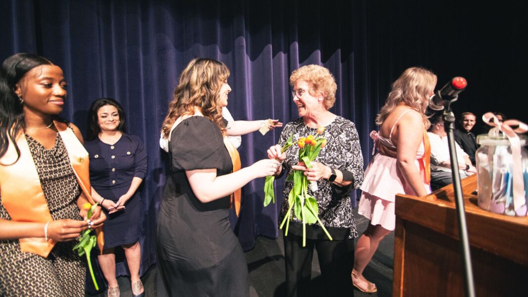 Strickert receives flowers from the graduating Newman University class of 2024.