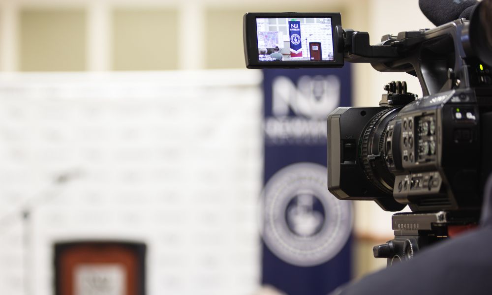 Video camera ready to record media conference at Newman University.