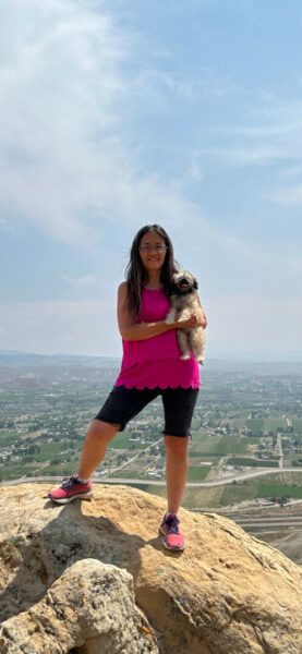 Becky smiles with her furry friend overlooking a city. (courtesy photo)