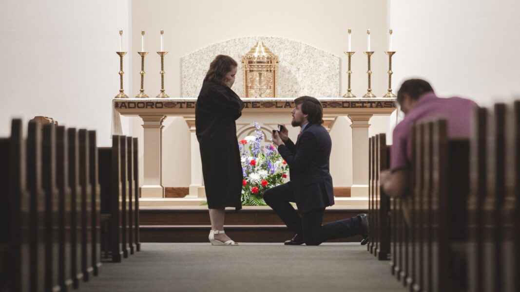 Student Suffield proposes to Umbarger in St. John's Chapel following the Baccalaureate Mass for graduates. (She said "yes!")