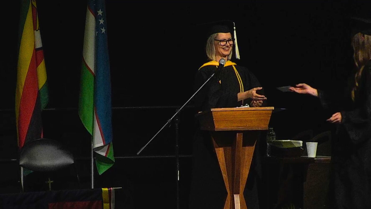 Sonja Bontrager announces the names of graduates at the 2024 commencement ceremony.