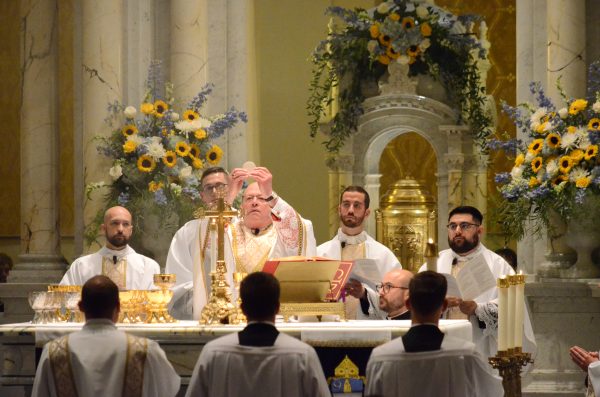 Bishop Kemme holds up the Eucharist during the ordination Mass in the cathedral. (Courtesy photo, Catholic Advance)
