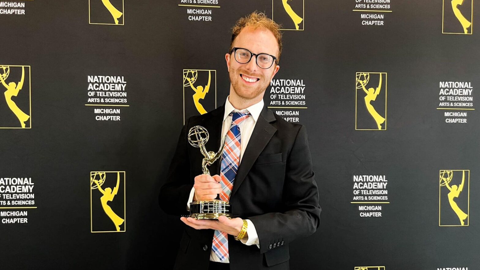 Riedl with his Emmy Award for his "Portraits of the Call" video project with the Diocese of Lansing in Michigan.