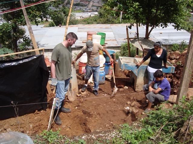 Ralls (left) works with fellow Newman students on a service project in Guatemala.