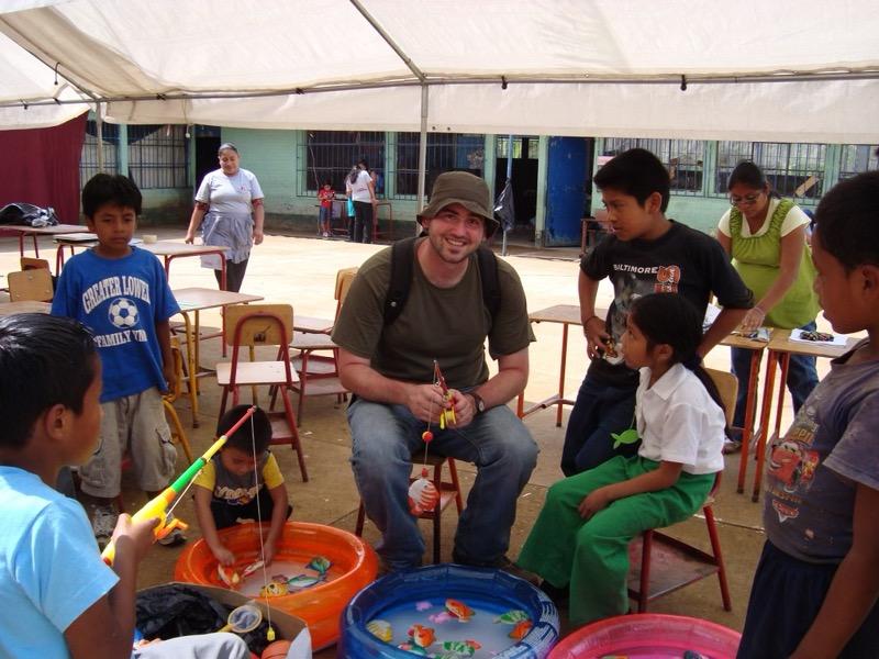 Ralls "fishes" with children in Guatemala