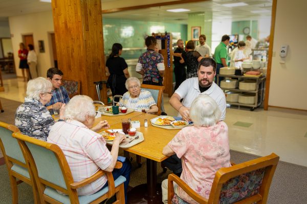 The seminarians in the Spanish immersion program at Newman University eat lunch with the Sister Adorers of the Blood of Christ after one of the classes they take at the motherhouse. Facing the camera, from left are Thomas Elliot, Sr. Tarcisia Roths, and Kyle Pfeifer. (Advance photo)