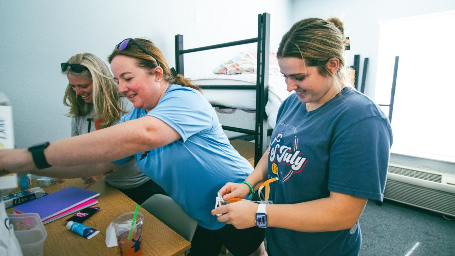 A student and her family members help move her into the residence halls during move-in day at Newman University.