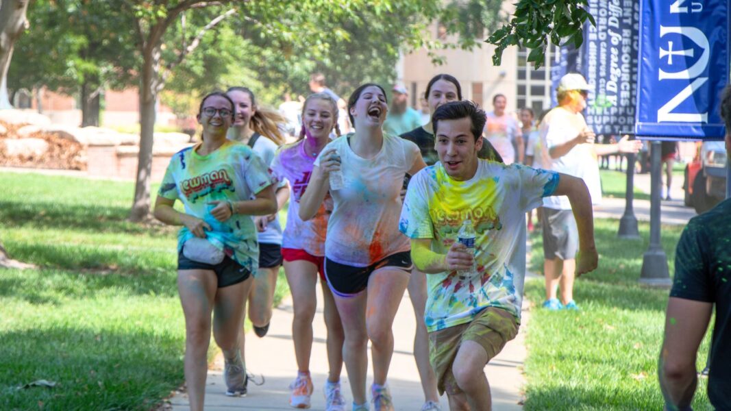 Members of the Newman bowling teams laugh while running the Color Run Aug. 24.