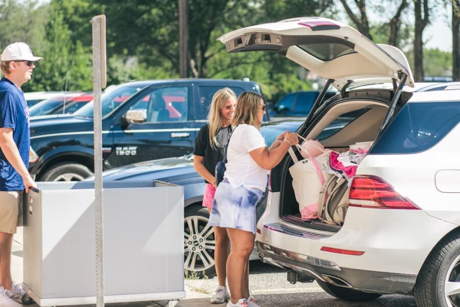 Parents and student Avery Gunert unload their vehicle on move-in day.