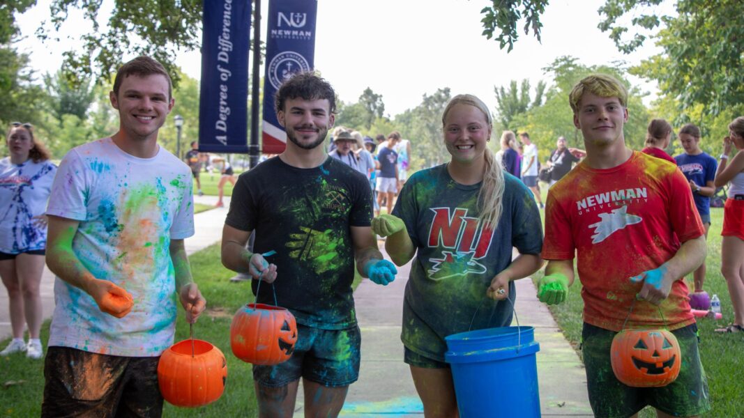 Bartlett (second from left), Alex and Colby hold their containers of colorful powder during Newman's second annual Color Run.