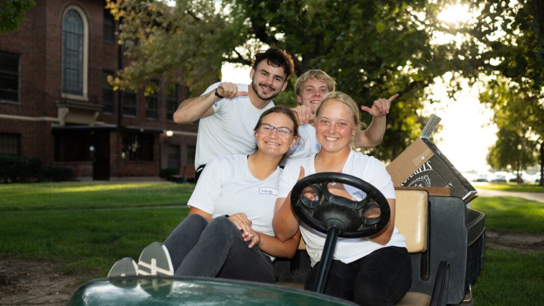 (From left to right, back row) Student volunteers Kaven Bartlett, Colby Schreiner, (front row) Haleigh Pearson and Alex Schreiner load up the golf cart during Party on the Plaza.