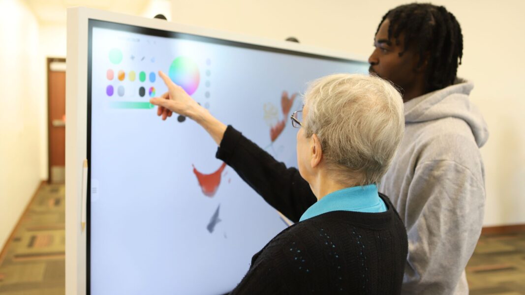 Sister Mary Kevin points to a color wheel on the digital smart board.