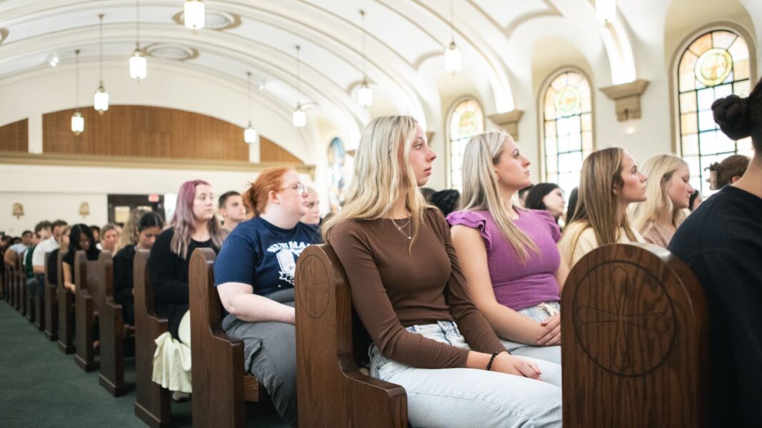 First-year students of Newman University listen to Bishop Kemme's homily.