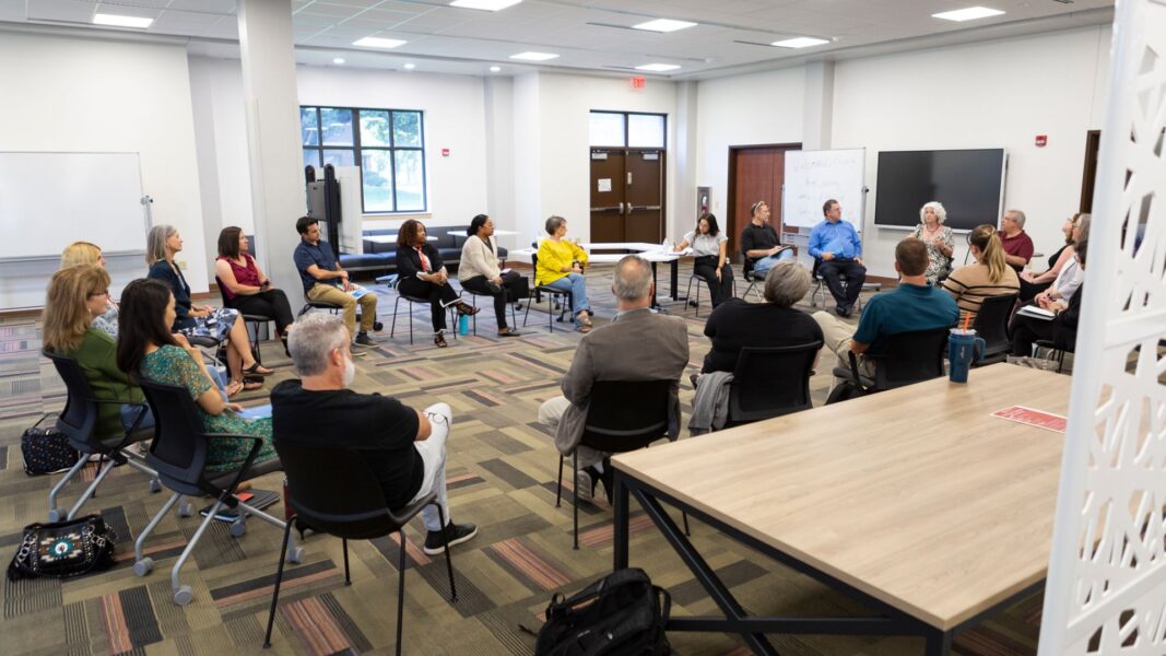 Newman faculty come together for a discussion following an off-campus faculty retreat Sept. 3.