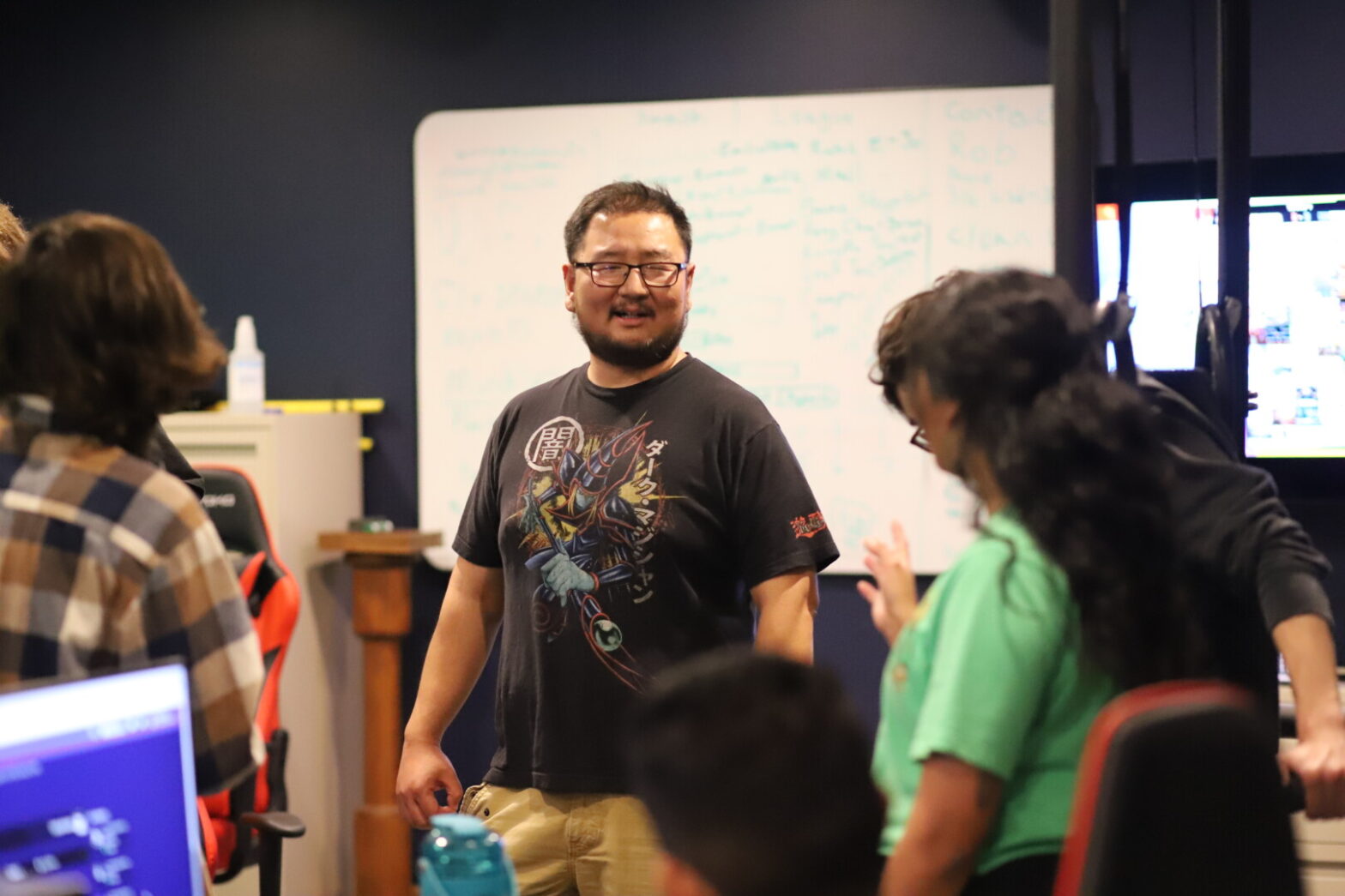 Esports coach viet hoang smiling during esports tournament at newman university