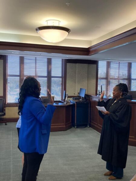 Altenor swearing-in/reciting oath of attorneys at a ceremony at U.S. District Court.