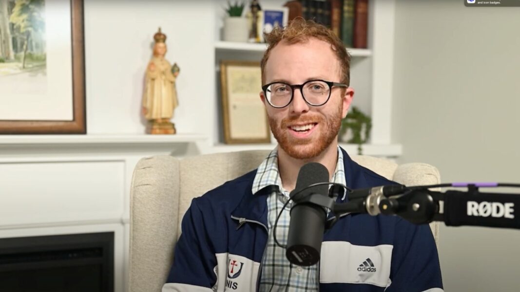 Matt Riedl sits in front of a mic during the filming of "The Newman Bond" podcast episode.