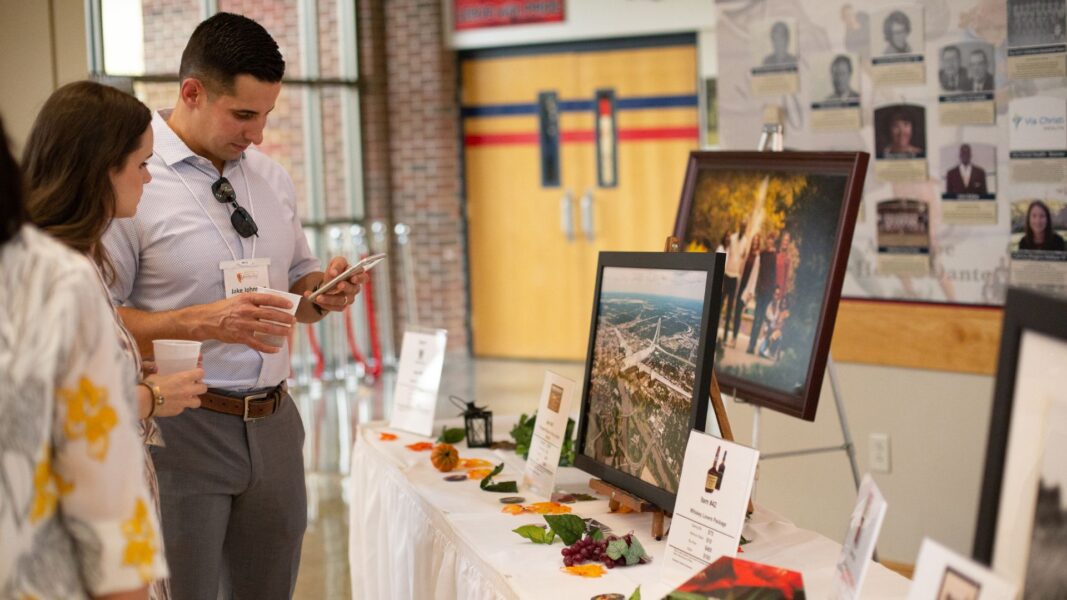 Guests of Party on the Plaza peruse silent auction items.