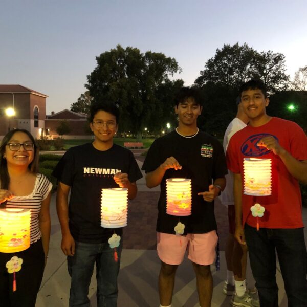 Students hold up paper lanterns during the moon festival.