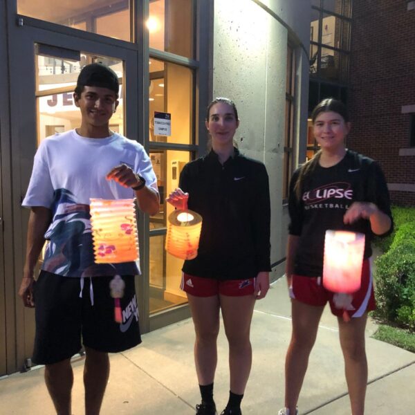 Students hold up paper lanterns during the moon festival.