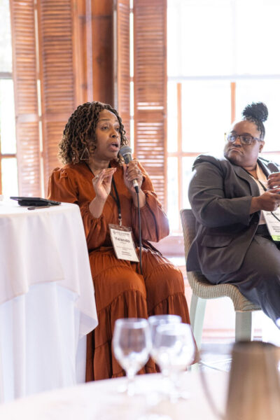 Johnson with the microphone during the panel discussion, “Allyship as a Leadership Skill: Supporting Underrepresented Colleagues."