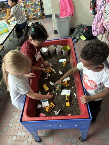 Students get their hands dirty in the "dig site" of Arellano's classroom.