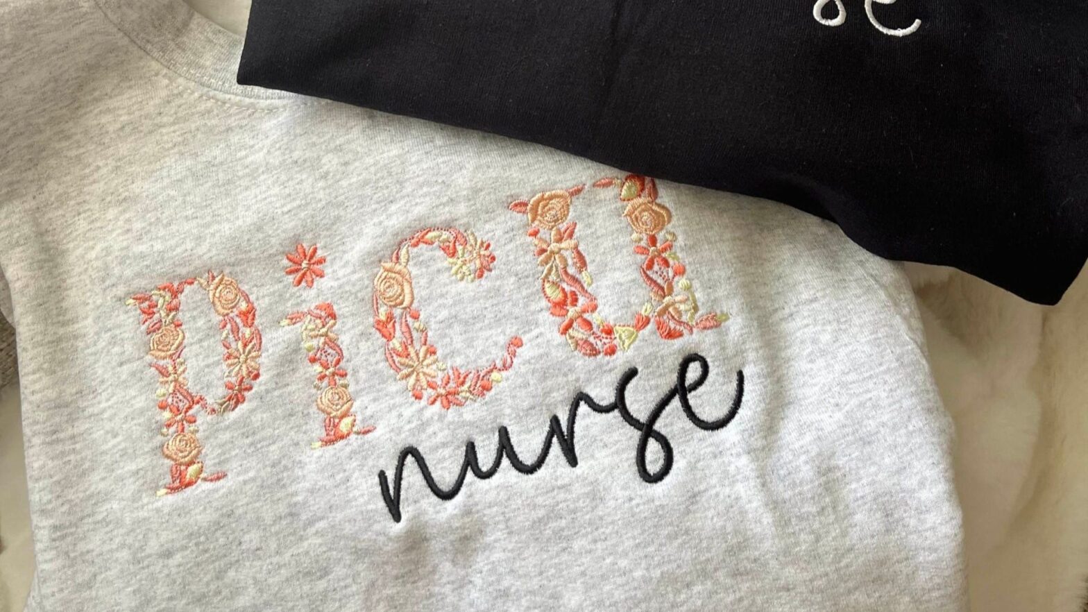 An embroidered sweatshirt reads "picu nurse."