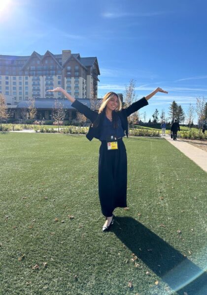 Nunez stands with her hands happily in the air for a photo.