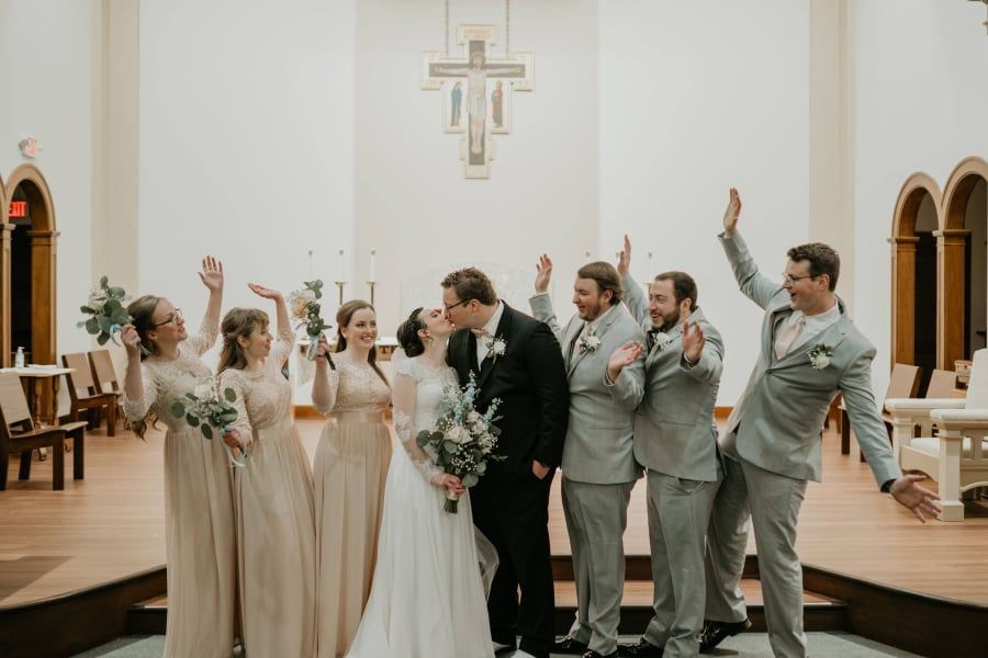 Schneiders and Maddie (center) were married in St. John's Chapel at Newman. (Photo by Brianna Huynh)