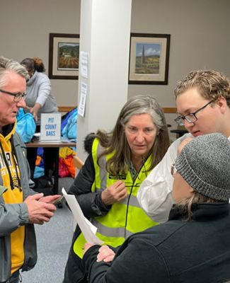 Schneiders (right) with fellow Newman grads JV Johnston (left) and Anne Fox (middle) at homeless initiative event. (Courtesy of United Way of the Plains)