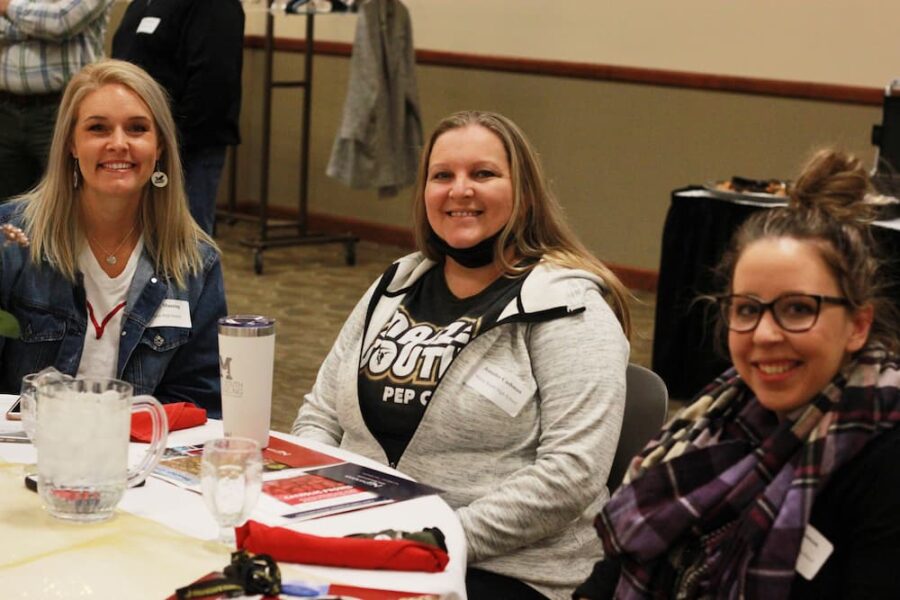 Three counselors enjoy the counselor breakfast at Newman University.