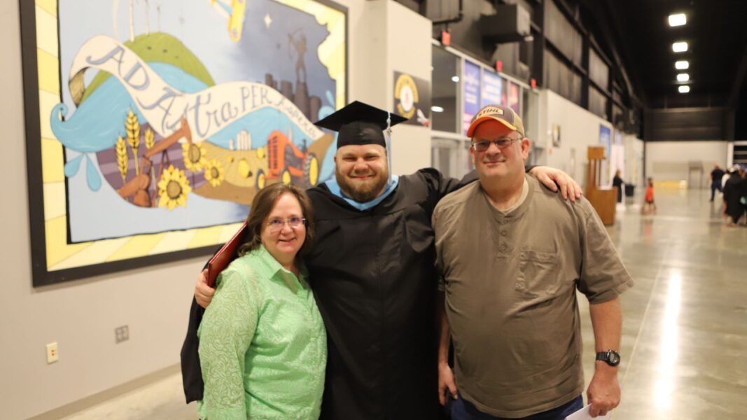 Rydman with his parents following his graduation ceremony in May 2024 from Newman University.